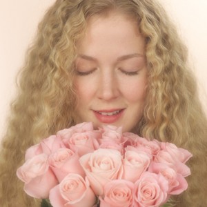 Woman Smelling Pink Roses